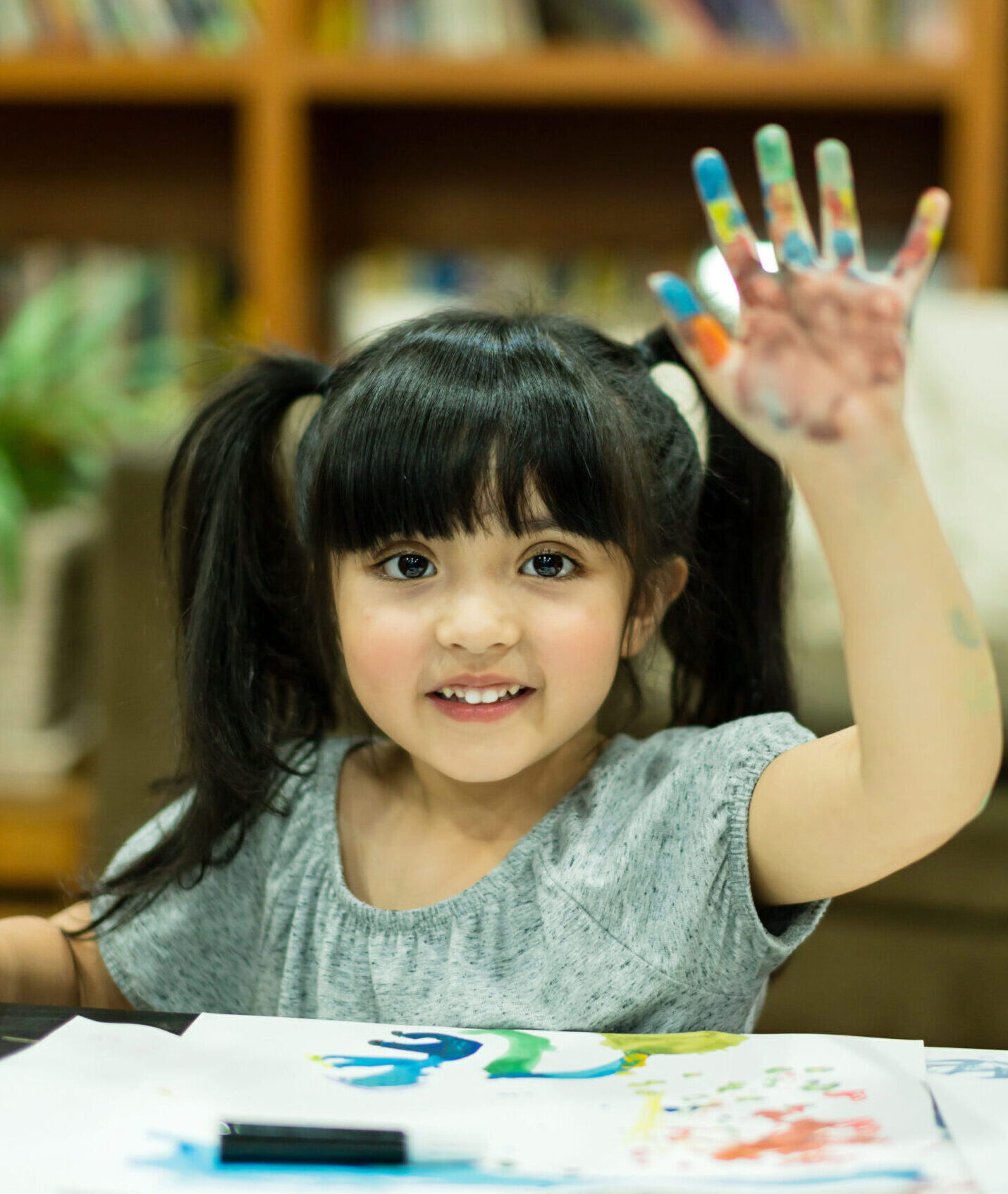 cheerful girl kid enjoy color painting with creativity ideas present and messy hand at home