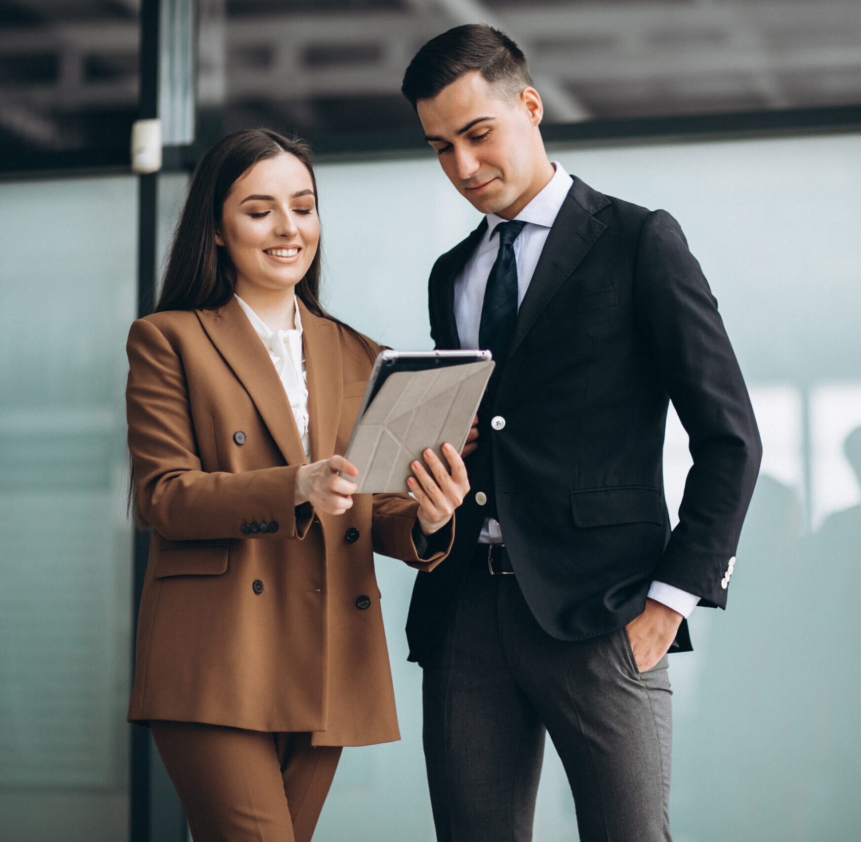 Male and female business people working on tablet in office