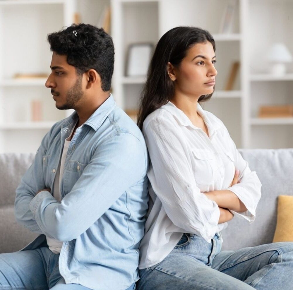 stock-photo-young-indian-couple-sits-back-to-back-on-sofa-surrounded-by-a-tense-atmosphere-visibly-upset-and-2373708913-transformed