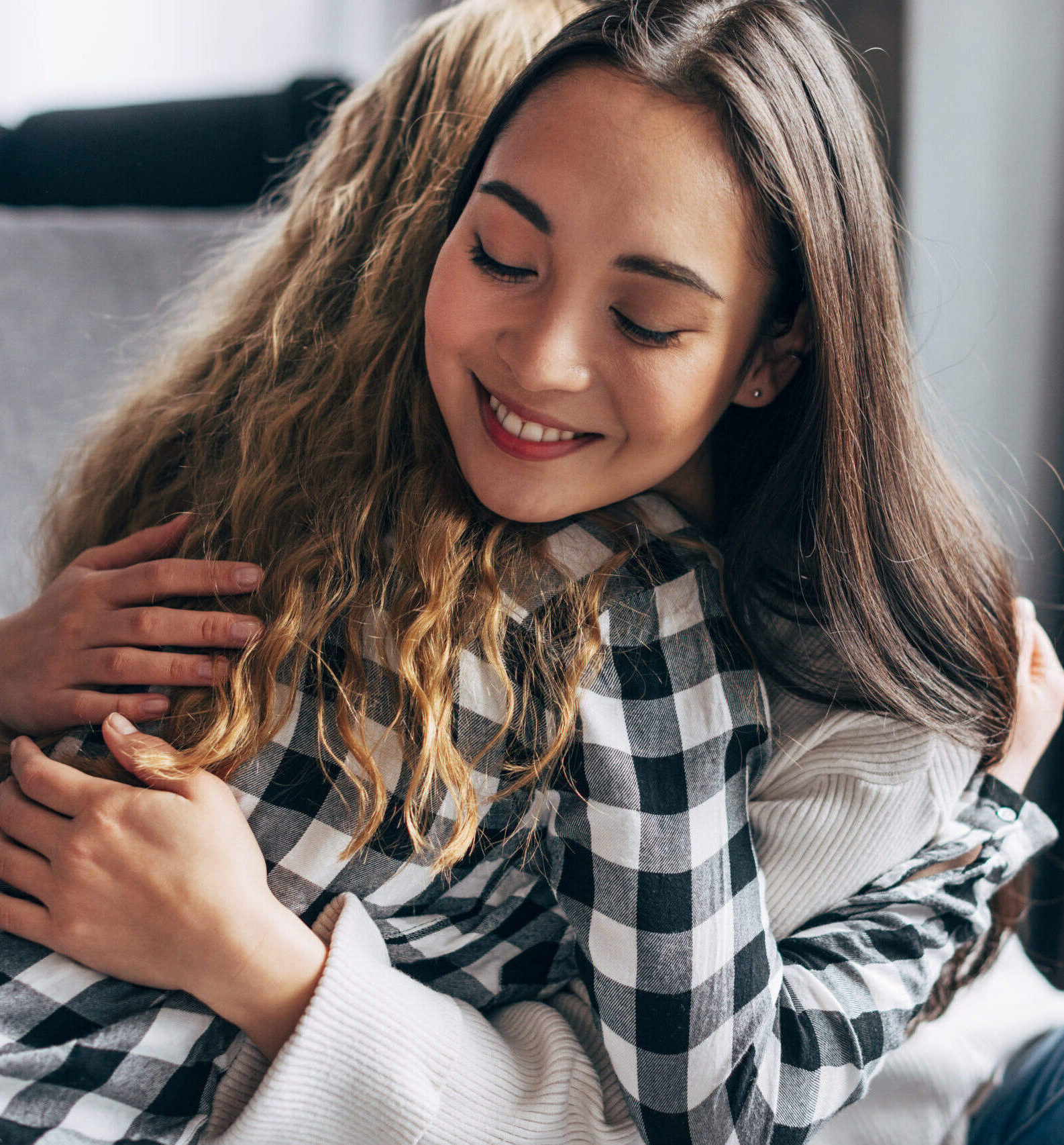 young-females-embracing-while-sitting-floor